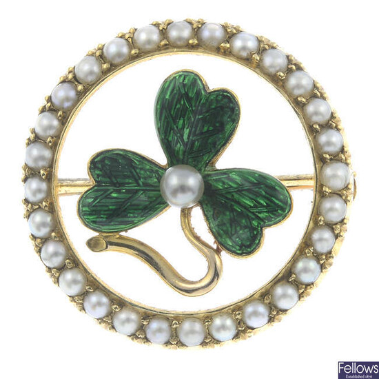 A split pearl and green enamel brooch.