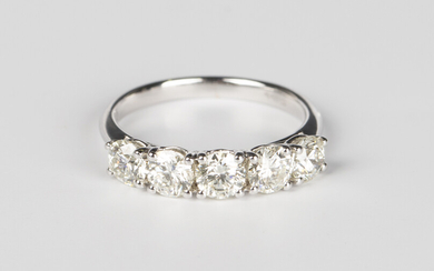 A white gold and diamond five stone ring, claw set with a row of circular cut diamonds, detailed