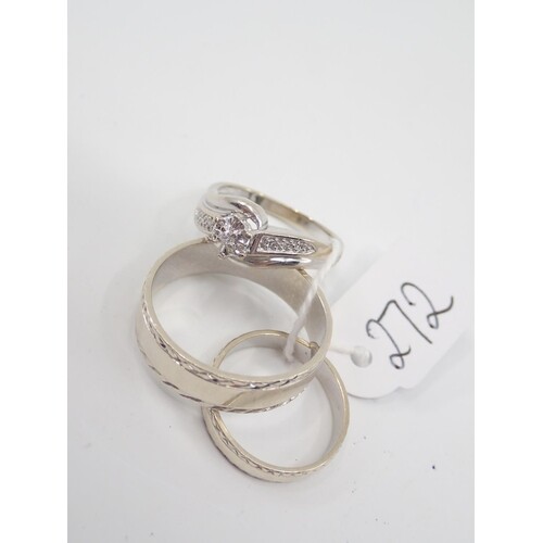 A white gold diamond ring and two white gold band rings appr...