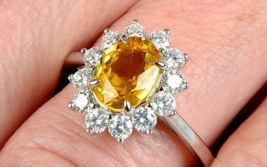 A yellow sapphire and brilliant-cut diamond cluster ring.