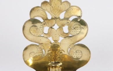 An 18th century brass wall sconce, Dutch, circa 1700, the backplate slightly convex and pierced with