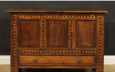 An 18th century design oak mule chest, hinged top above thre...