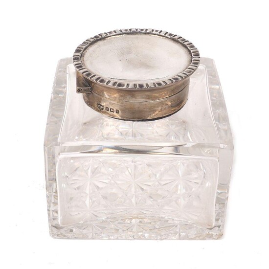 An Edwardian silver mounted glass inkwell, Birmingham, 1909, Mappin & Webb, the square cut glass body to a silver collar with hinged, crimped lid, 10.8cm high, base 11 x 11cm