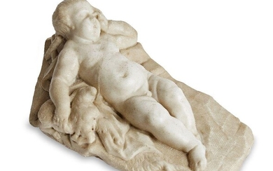 An Italian marble model of the Sleeping Christ Child, late 17th/early 18th century, depicted on a rockwork base holding a lamb and cross, 40cm wide