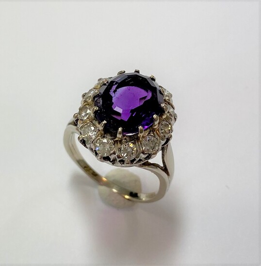 An amethyst and diamond oval cluster ring