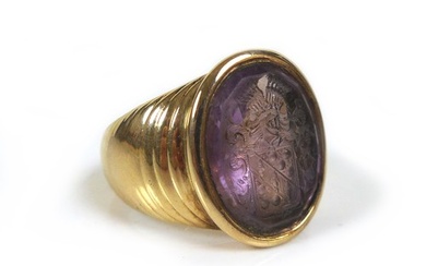 An amethyst intaglio inset within a 9ct gold signet ring, un...