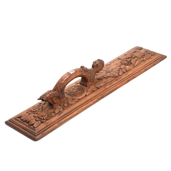 An early 19th century oak mangle board, carved in relief with flower...