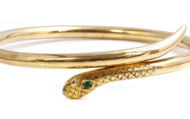 An early 20th century gold emerald and diamond set serpent or snake bangle