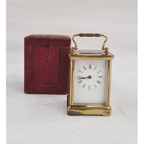 Brass and five-sided glass carriage clock in leather carry c...