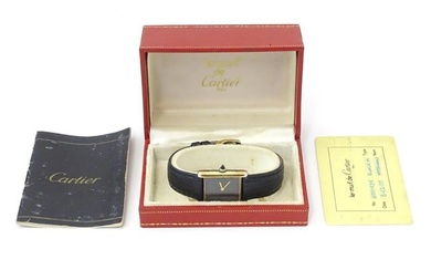 Cartier : A 1970's Les Must de Cartier silver gilt cased wrist watch with black dial, marked to the