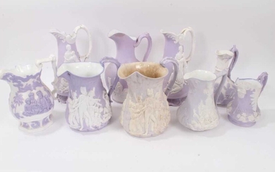 Collection of nine 19th century relief moulded lilac-ground jugs, mostly Samuel Alcock, including the Portland Jug, Naomi and her Daughters in Law, etc, the largest measuring 29cm height