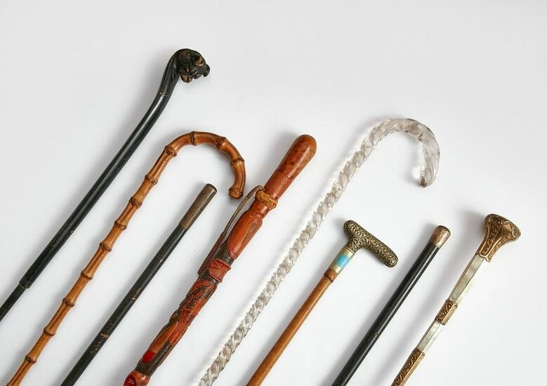Collection of seven walking sticks and a parasol