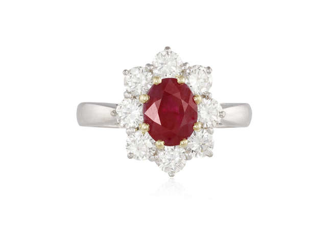 Description A RUBY AND DIAMOND CLUSTER RING The oval-shaped...