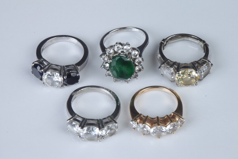 FIVE FAUX DIAMOND AND COLORED STONE "TRAVEL RINGS". Including one...