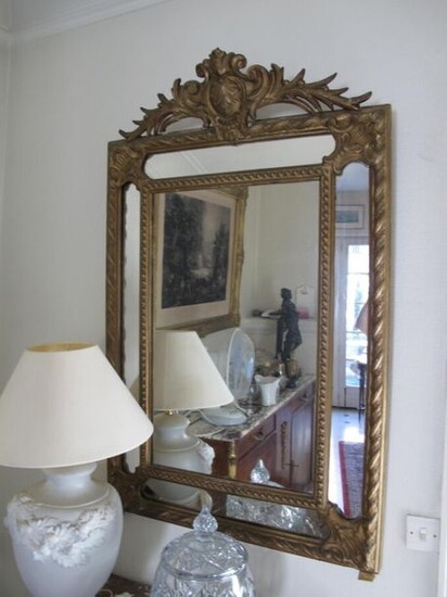 Gold lacquered wood glazed mirror, the pediment decorated with a cartouche.