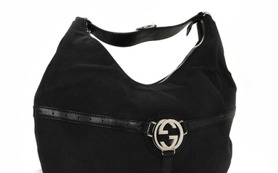 SOLD. Gucci: A "Reins Hobo" bag made of black canvas with black leather trimmings and...