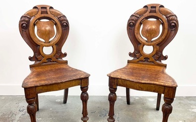 HALL CHAIRS, a pair, Victorian oak, with ornately carved and...