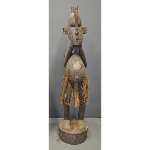 Large Western African carved hardwood male village figure/st...