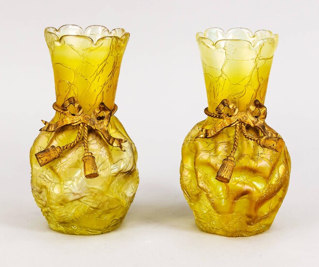 Pair of Art Nouveau vases, early of 20th century, round stand, bulgy body, slightly flared neck, rim in the shape of a flower, yellowish glass, structured wall, metal assembly in the form of a loop, 1 with hairline crack, h. 20.5 cm