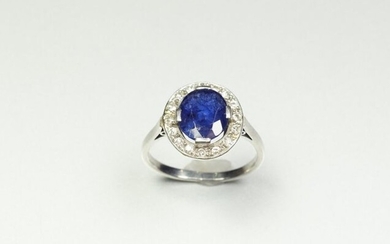Platinum ring (850/oo) centered on an oval sapphire calibrating approximately...