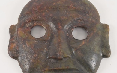 Pre-Columbian original carved stone mask. Green stone with red veining. Provenance: purchased from