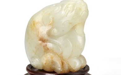 Property of a Gentleman (lots 36-85) A Chinese celadon green and russet jade bixie carving, 17th/18th century, finely carved seated on its haunch with ruyi-shaped ears and finely detailed tail and feet to underside, with small vertical hole through...