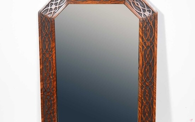 Rectangular bevelled glass wall mirror in carved oak frame with canted corners.