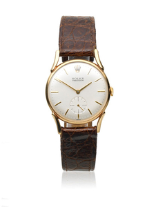 Rolex. A 9K gold manual wind wristwatch