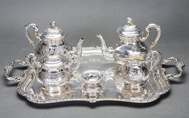 Set of coffee and tea in Spanish silver punched composed of: coffee pot, teapot, sugar bowl, vase and strainer with chiselled decoration of vegetable elements and flowers. On rectangular tray with handles with field engraved with the same decorative...