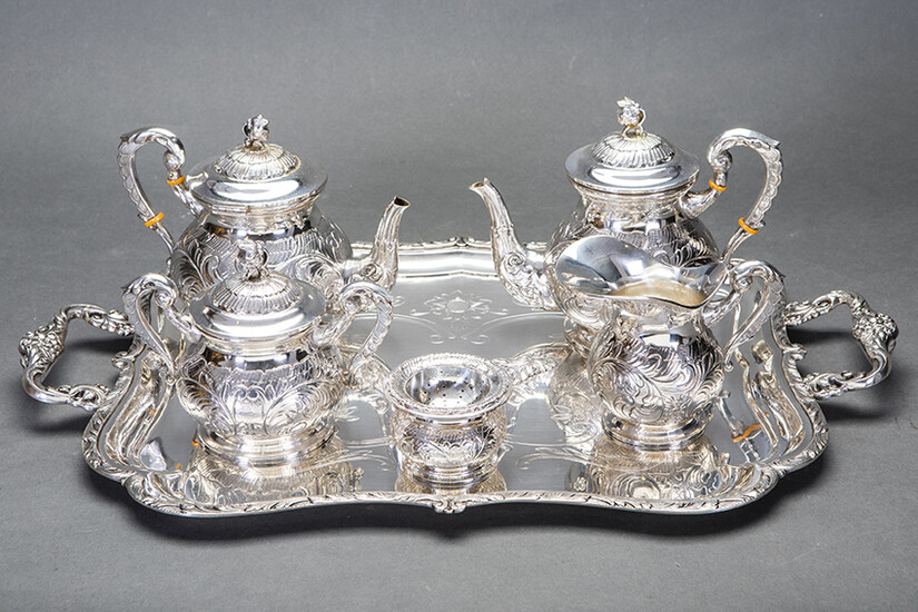 Set of coffee and tea in Spanish silver punched composed of: coffee pot, teapot, sugar bowl, vase and strainer with chiselled decoration of vegetable elements and flowers. On rectangular tray with handles with field engraved with the same decorative...