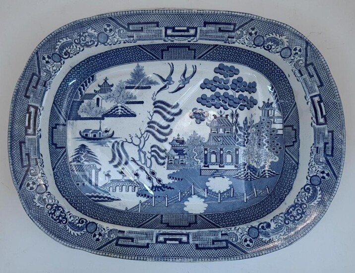 Three Victorian blue and white transfer print meat plates, to include: a hexagonal example decorated with an English classical landscape to the well, with foliate decorated border to the rim, 50.5cm long; and two oval Chinoiserie examples decorated...