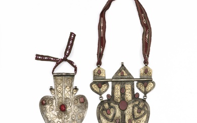 Turkmenistan, Tekke, a silver and ormolu heart-shaped back pendant, asik, set with cornelian, woven strap; herewith an other with gilded ppliques, coloured stones and a woven strap.