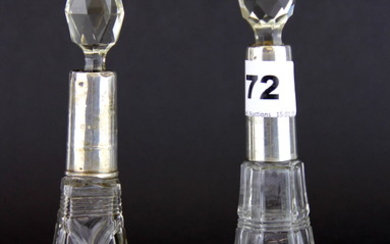 Two hallmarked silver rimmed cut glass perfume bottles, tallest H. 19cm.