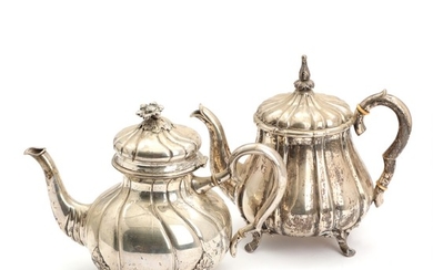 Two silver tea pots. Maker P. Hertz 1862 and 1915. Weight app. 1250 gr. H. 19 and 20 cm. (2)