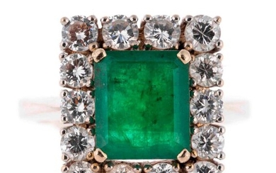 White gold ring centered with an emerald cut emerald of...