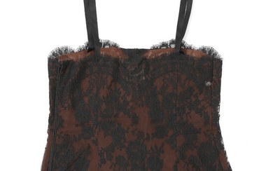 SOLD. Yves Saint Laurent: A dark brown lace top with black lacing, straps and a...