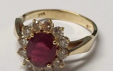 14K GOLD RUBY & DIAMOND CLUSTER RING THE OVAL RUBY SET WITHI...