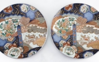 TWO IMARI PORCELAIN CHARGERS Finely enameled and gilt decoration on central scroll and fan cartouches. Diameters 21.5".