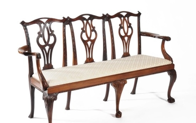 A carved mahogany chair back settee, in George III style
