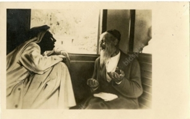 A Jew and an Arab talking on a train - a real photo postcard. The 1930s