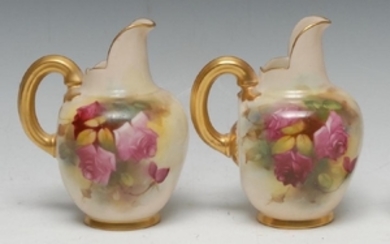 A pair of Royal Worcester flat sided jugs, painted with