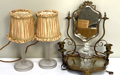 A 19th century gilt metal dressing table mirror; together with a moulded glass table candlestick