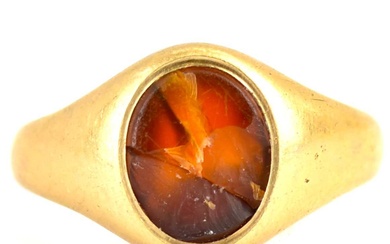 A 9ct gold signet ring with central amber oval, size...