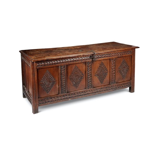A Charles II oak chest The twin-plank lid above a four-panel...