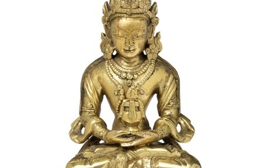 A Chinese gilt bronze crowned Amitayus Buddha with down cast eyes. 17th century. Weight 395 g. H. 11.5 cm.