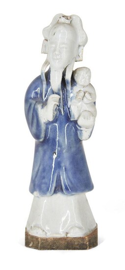 A Chinese porcelain figure, 18th century, modelled as a standing figure covered in a qingbai glaze with blue-glazed robes, with a baby cradled in his left arm, 17cm high