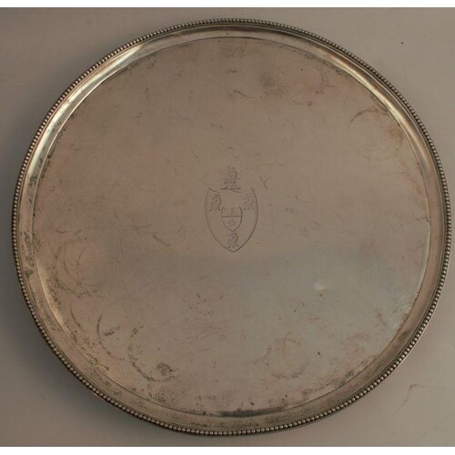 A Georgian silver salver, of circular form with beaded edge,...