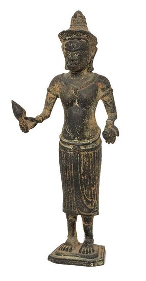 A Khmer bronze figure of Uma, 19th century, cast in the Angkor Way style, standing holding a lotus bud in her right hand and an orb in her left, 24cm high
