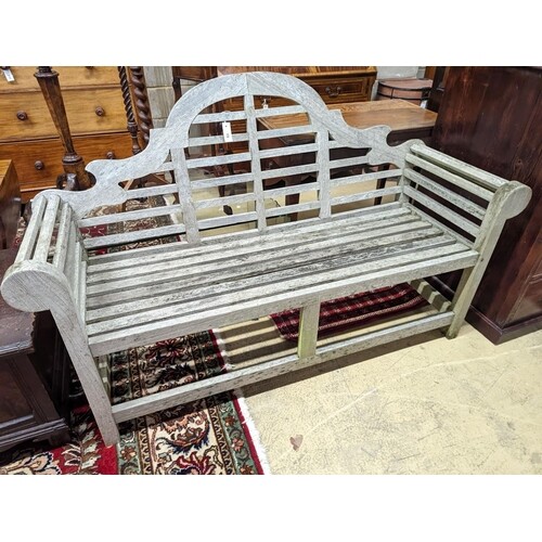 A Lutyens style weathered teak garden bench, length 166cm, d...