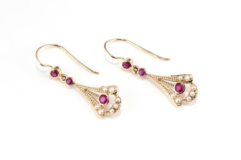 A PAIR OF EDWARDIAN STYLE RUBY AND PEARL EARRINGS; 9ct gold fan shape drops set with round cut treated rubies and seed pearls to she...